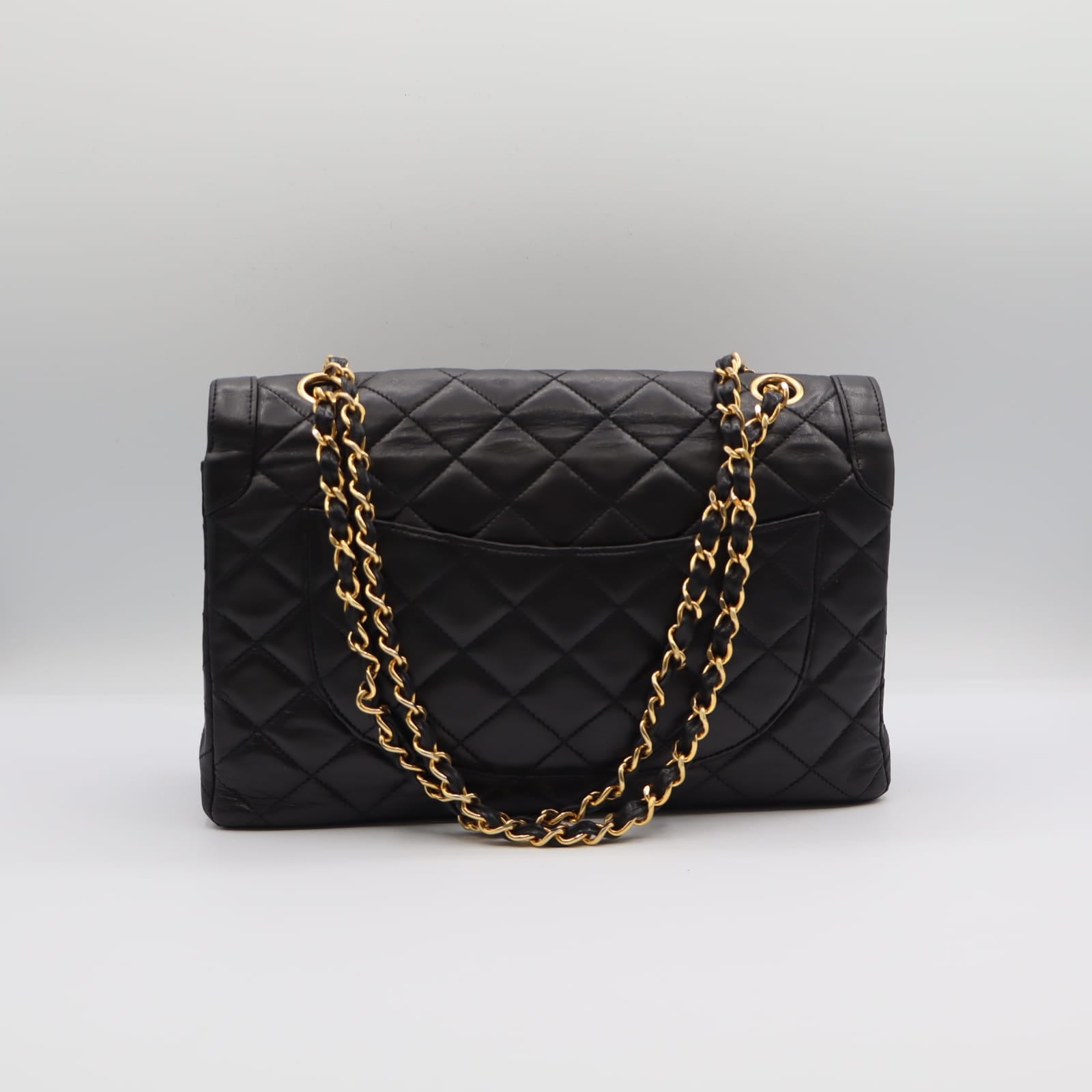 Sac Chanel Double Rabat en cuir noir matelassé, chaîne dorée entrelacée de cuir, vue arrière